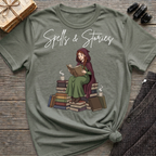 Spells & Stories - Reading Witch Sitting on a Pile of Books Graphic T-Shirt